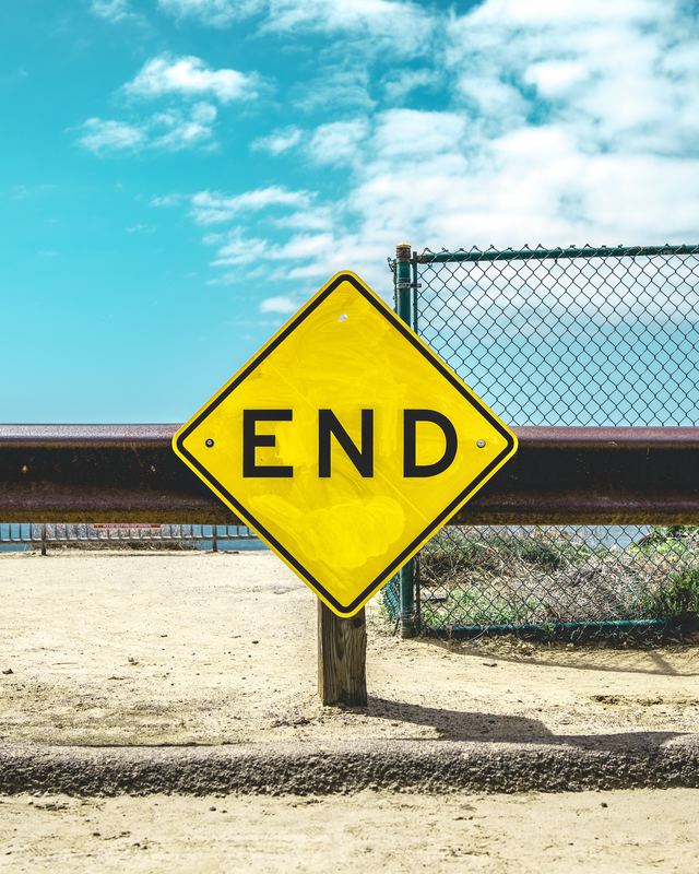 yellow diamond road sign that reads end