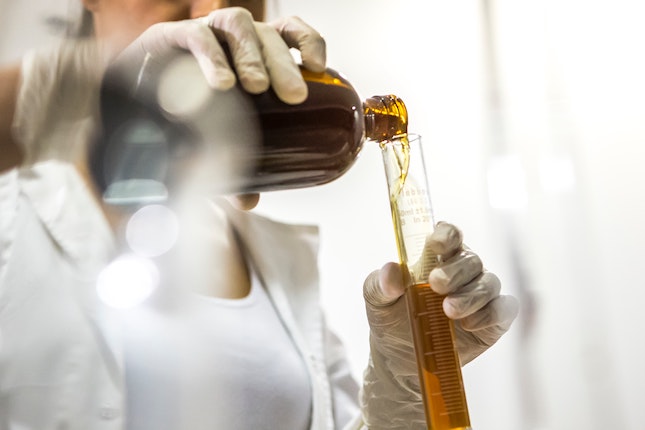 pouring honey into a test tube