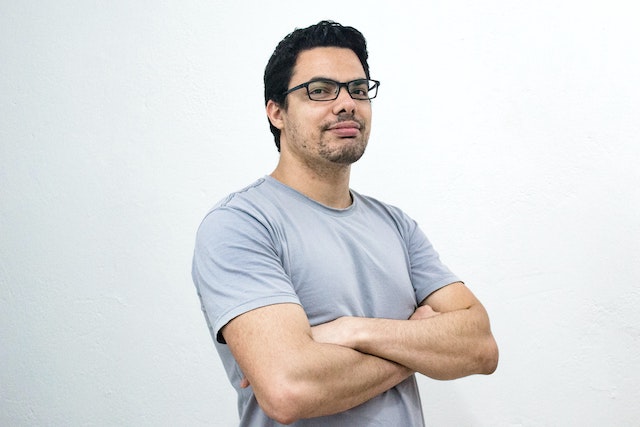 man wearing glasses with arms crossed across chest