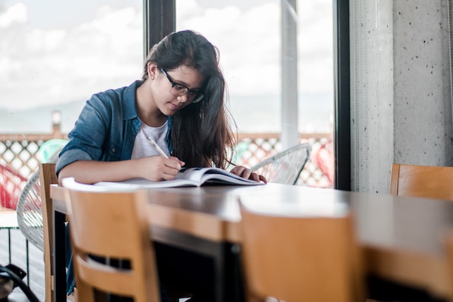 woman writing in notebook