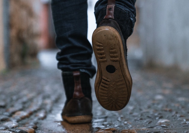 feet walking on cobblestones to illustrate novel pacing