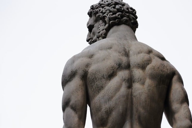 sculpture of Hercules seen from the back displaying a well-muscled back.