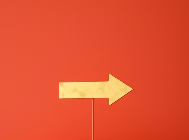 yellow arrow on a red stick pointing right