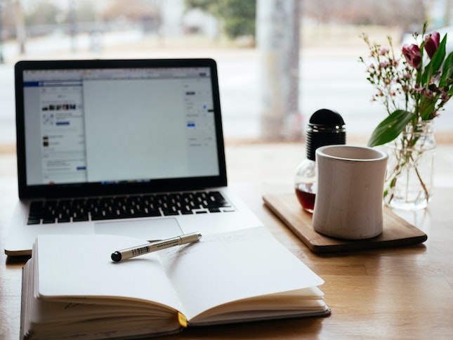 writers desk with notebook computer and coffee