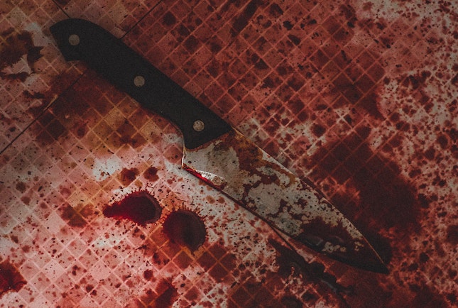 bloody knife in blood splatter as a mystery clue