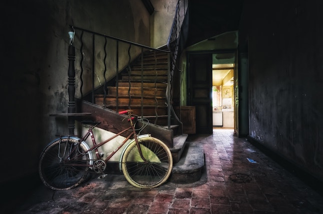 bicycle in an old shed with light pouring in an open door