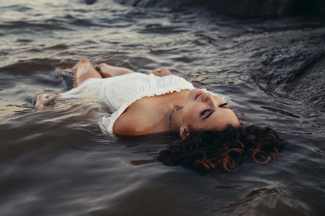 woman in white dress floating in water