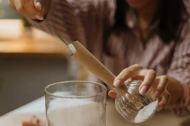 pouring sugar through a paper funnel illustrating a mystery's third act