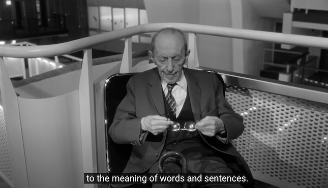 library scene from Wings of Desire with old man talking about the meaning of words and sentences