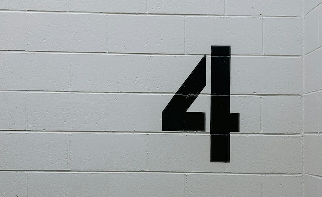 white wall with the number 4 stenciled in black