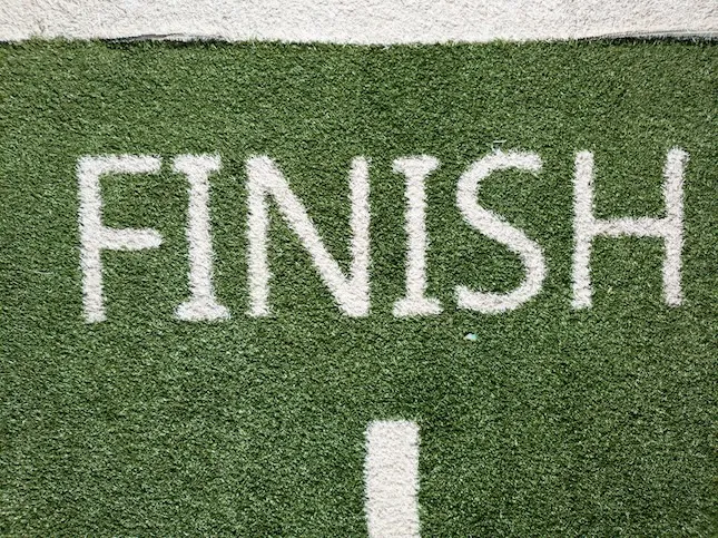 the word "FINISH" written in white on lawn to illustrate a quick mystery novel ending